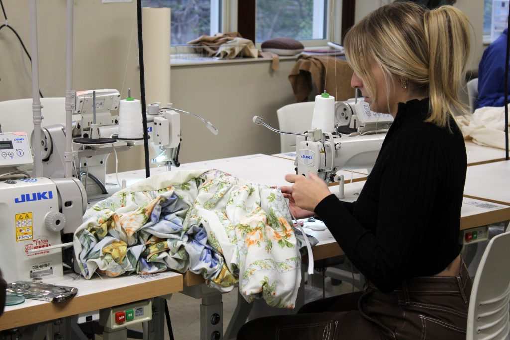 Student sews garment in Kellwood Apparel Lab.